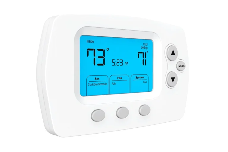 Digital thermostat with a blue backlit screen displaying an inside temperature of 79°F, set to 71°F. The time reads 5:23 PM. Buttons for set, fan, and system modes are visible.